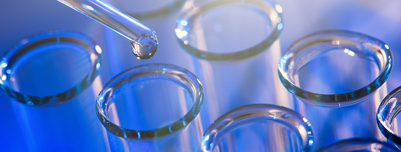 kilka pipet i probówek na niebieskim tle